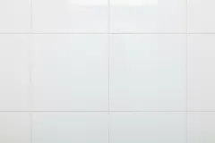 Witte keramische wandtegels in een badkamer of keuken, strak en schoon oppervlak.